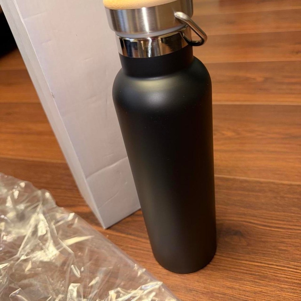 Black stainless steel water bottle with bamboo lid